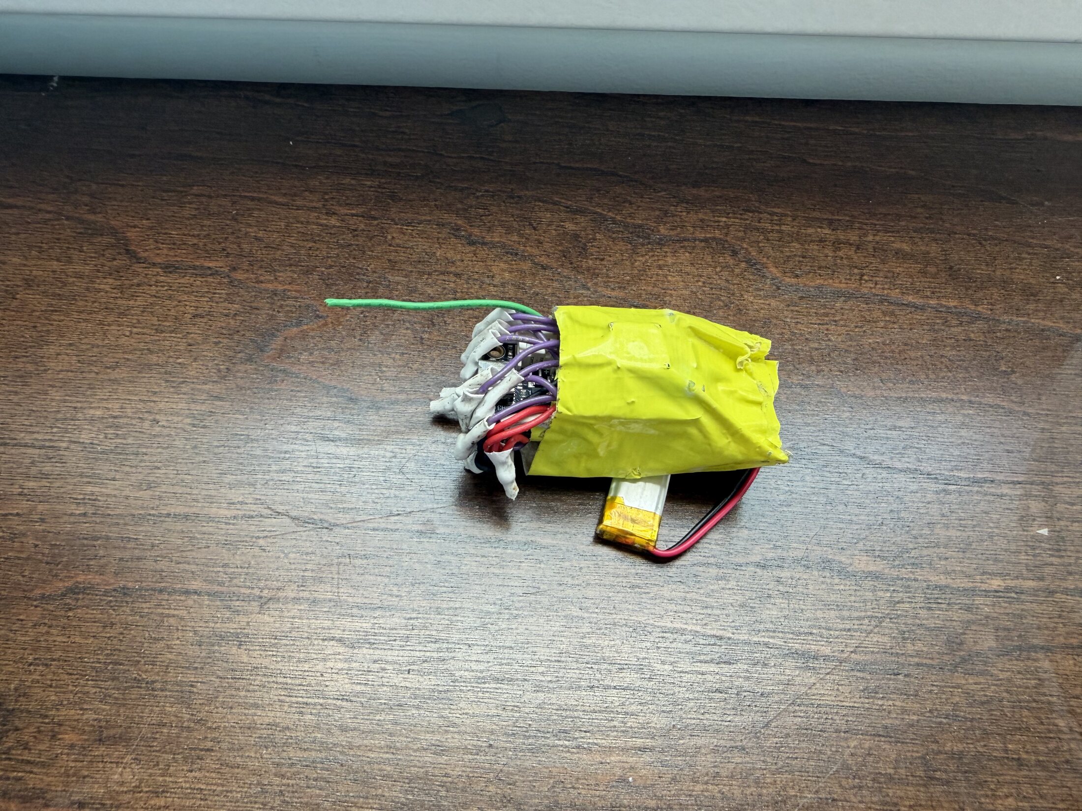 RP2040 payload electronics wrapped in Kapton tape with LiPo battery